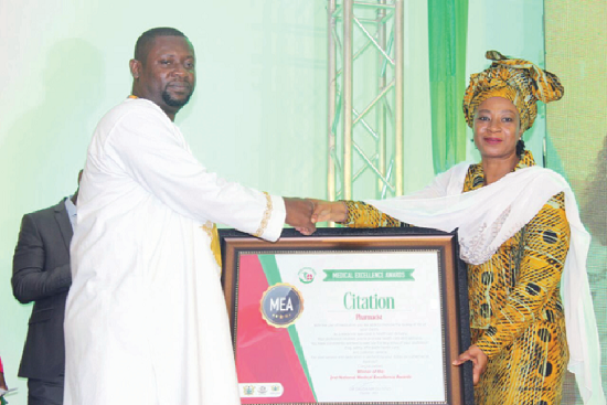 Mr Frank Adasi Peprah (left) receiving the overall best Pharmacist award from Ms Afisah Zakaria, Chief Director, Ministry of Health